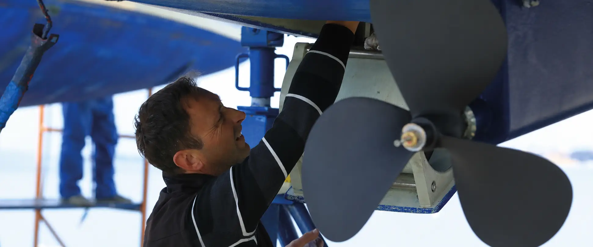 Specialists repairing yacht systems in a workshop