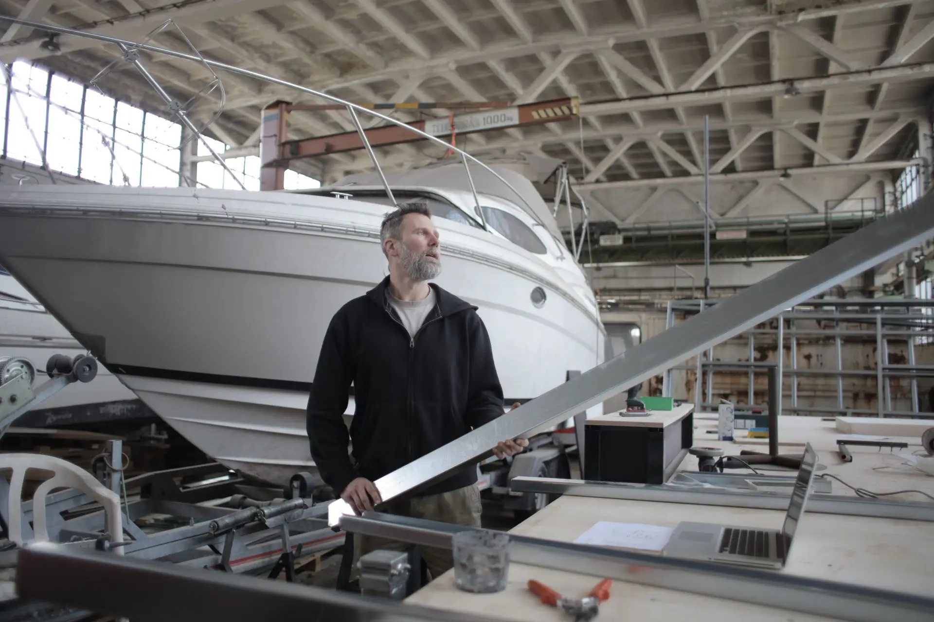 Craftsperson restoring timber inside a yacht cabin