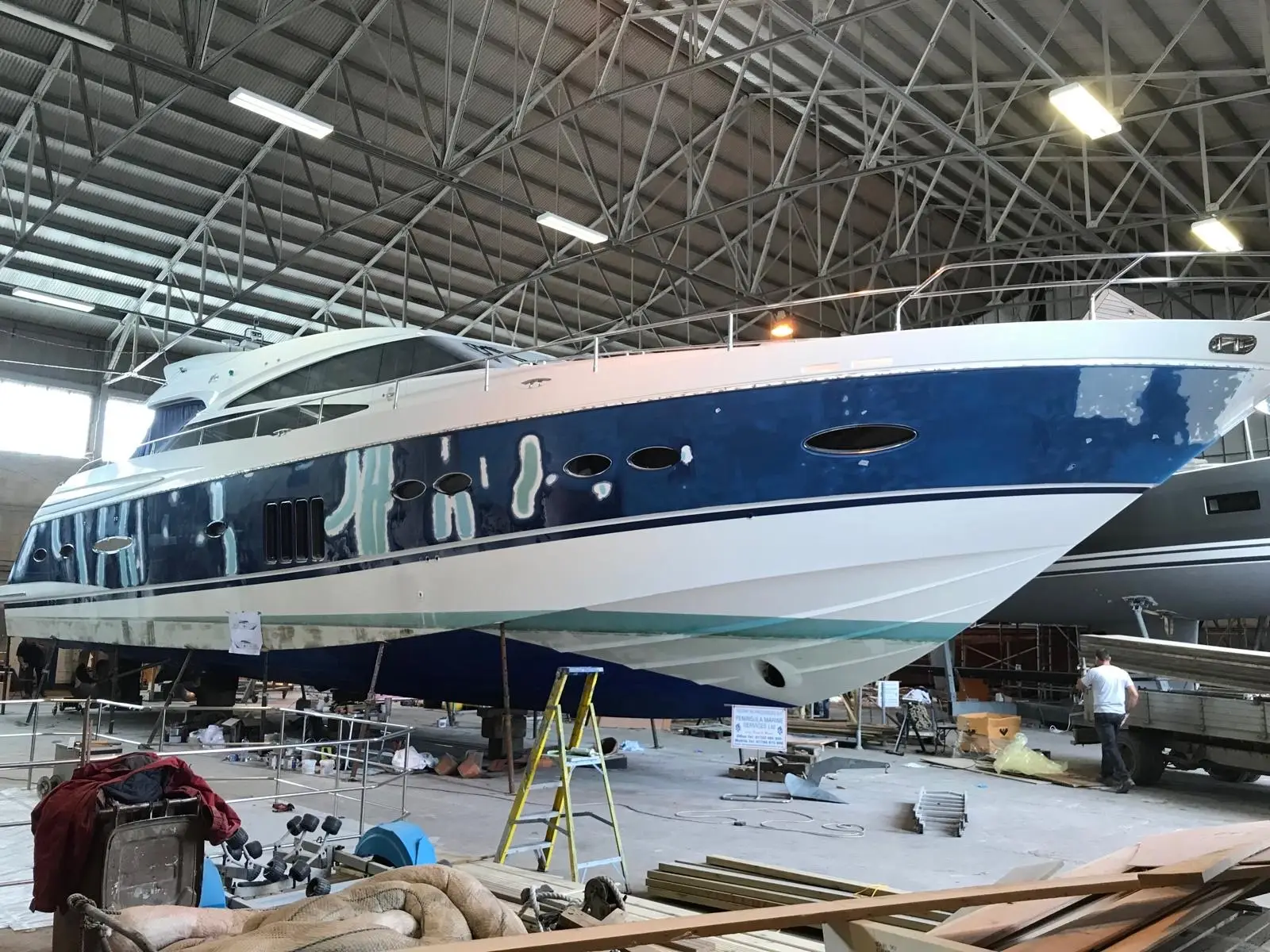 Marine specialist inspecting a yacht during repair